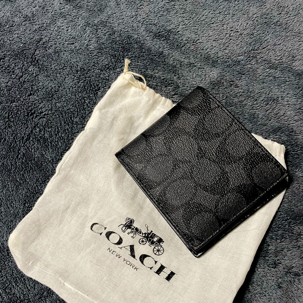 COACH WALLETS FOR SALE. One is black and the other one with the logo.